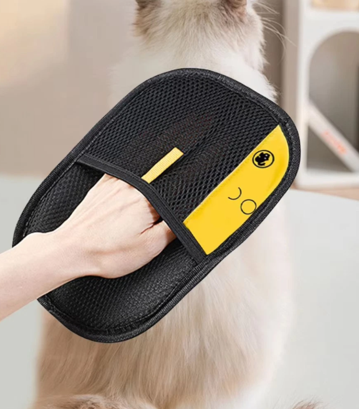 Cat grooming glove removing loose hair from cat fur